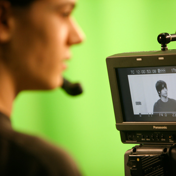 Student looking through film camera viewfinder