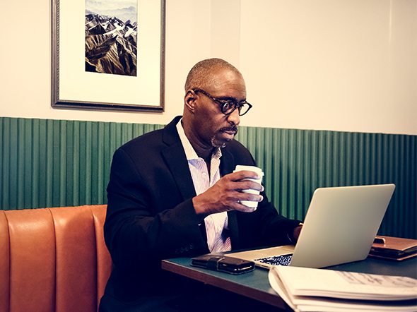 Man on laptop in restaurant