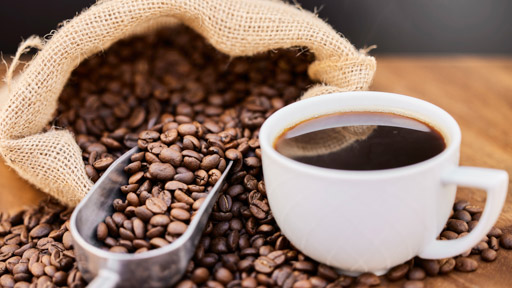 Image of coffee beans and a cup of coffee