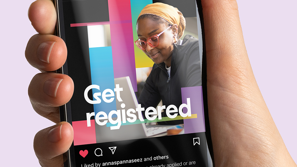 hand holding an iPhone, displaying a social media post by the university of hertfordshire