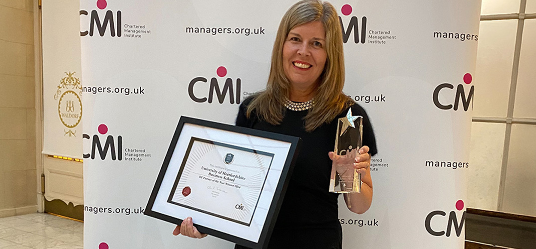 Woman holding CMI Award certificate 