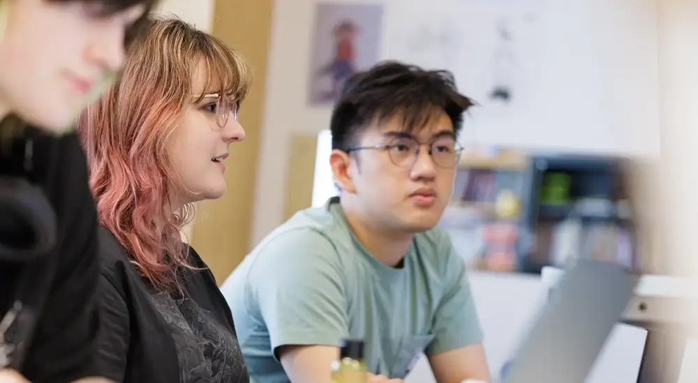 A group of student working on laptops