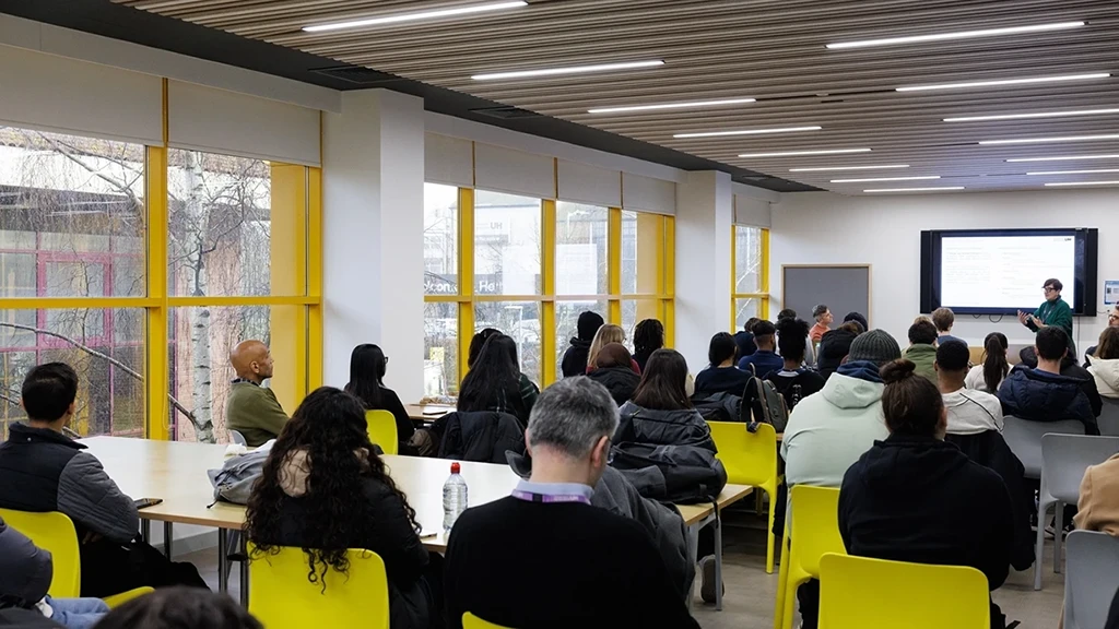 A class full of students listening to a lecturer