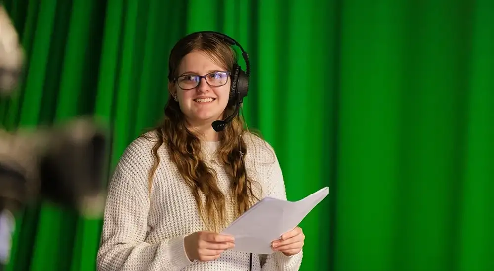 A student practicing being a producer