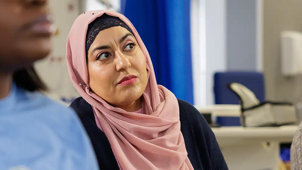 Student in a head scarf listening
