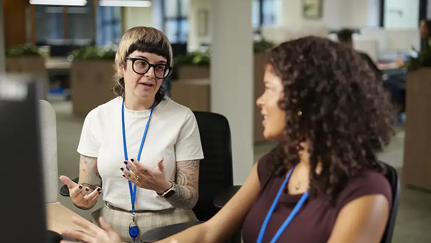 Two people talking in a community space