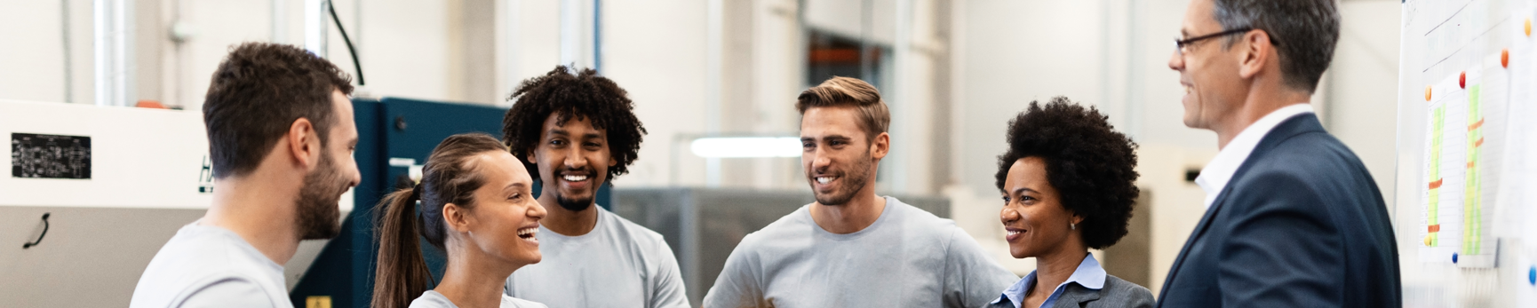 A group of men and women in group talking at work