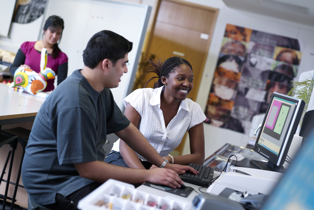 Black female student and male student working at computer