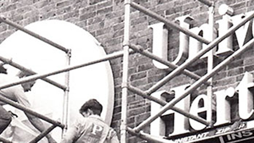 workers put up a University of Hertfordshire sign