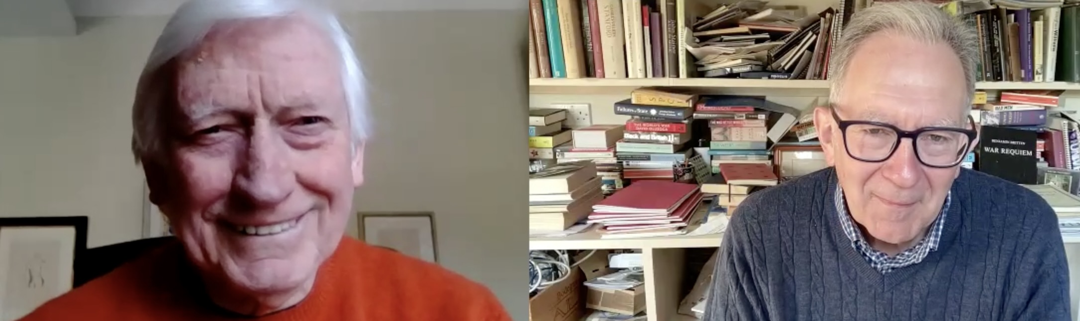 Man in red sweater on Zoom call with other man