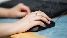 Hand on a computer mouse