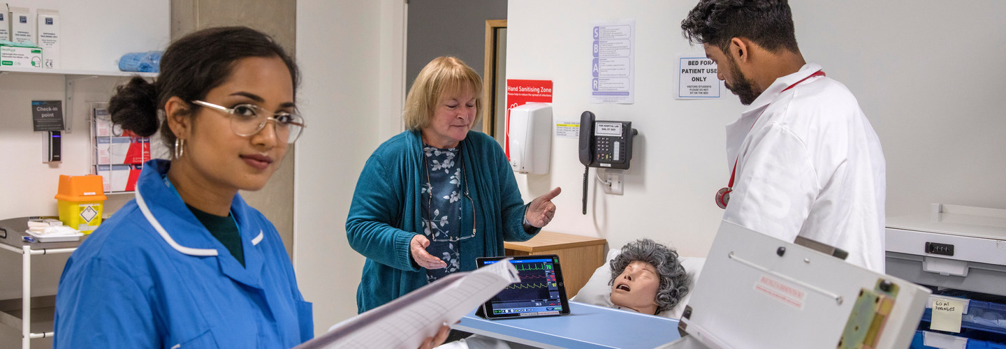 Nurse helping doctor on ward rounds