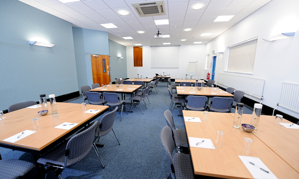 Meeting room with tables with groups of chairs