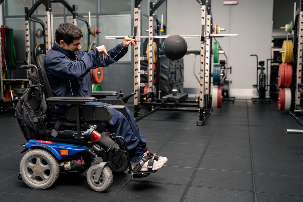 Man in wheelchair throwing ball