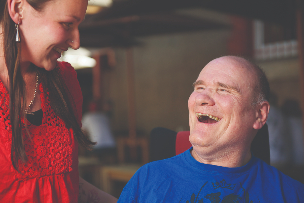 Man in wheelchair with carer