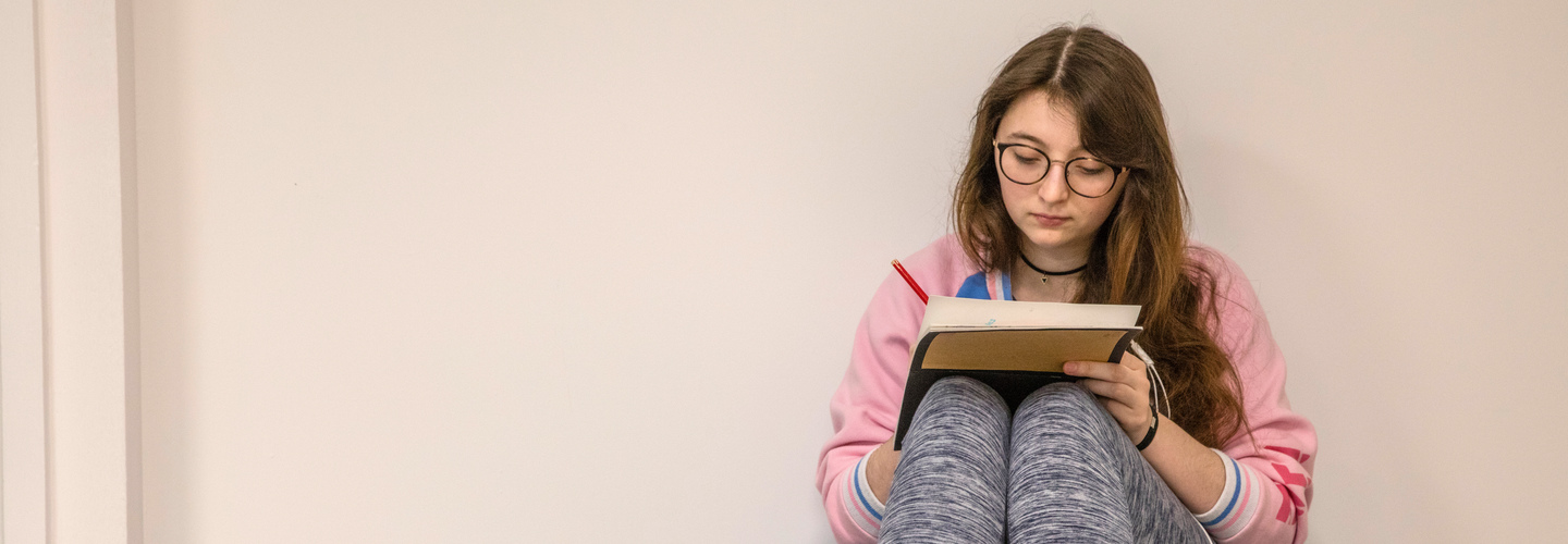 Student reading on the floor