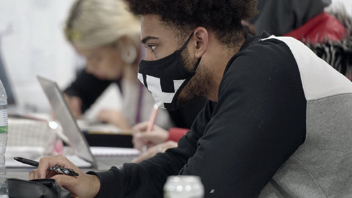 Male student studying in face mask