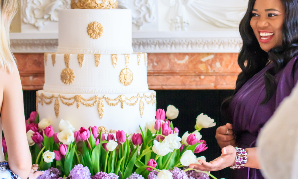 Tees Bakery owner standing next to a wedding cake