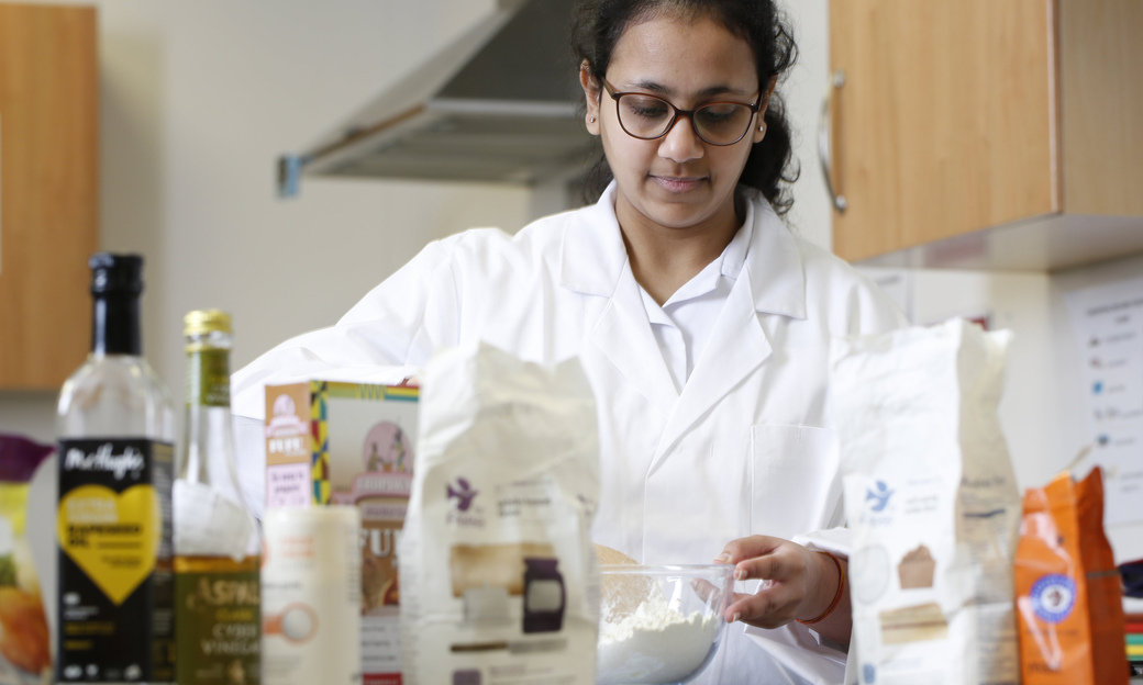 A female student following a recipe in one of the food labs 