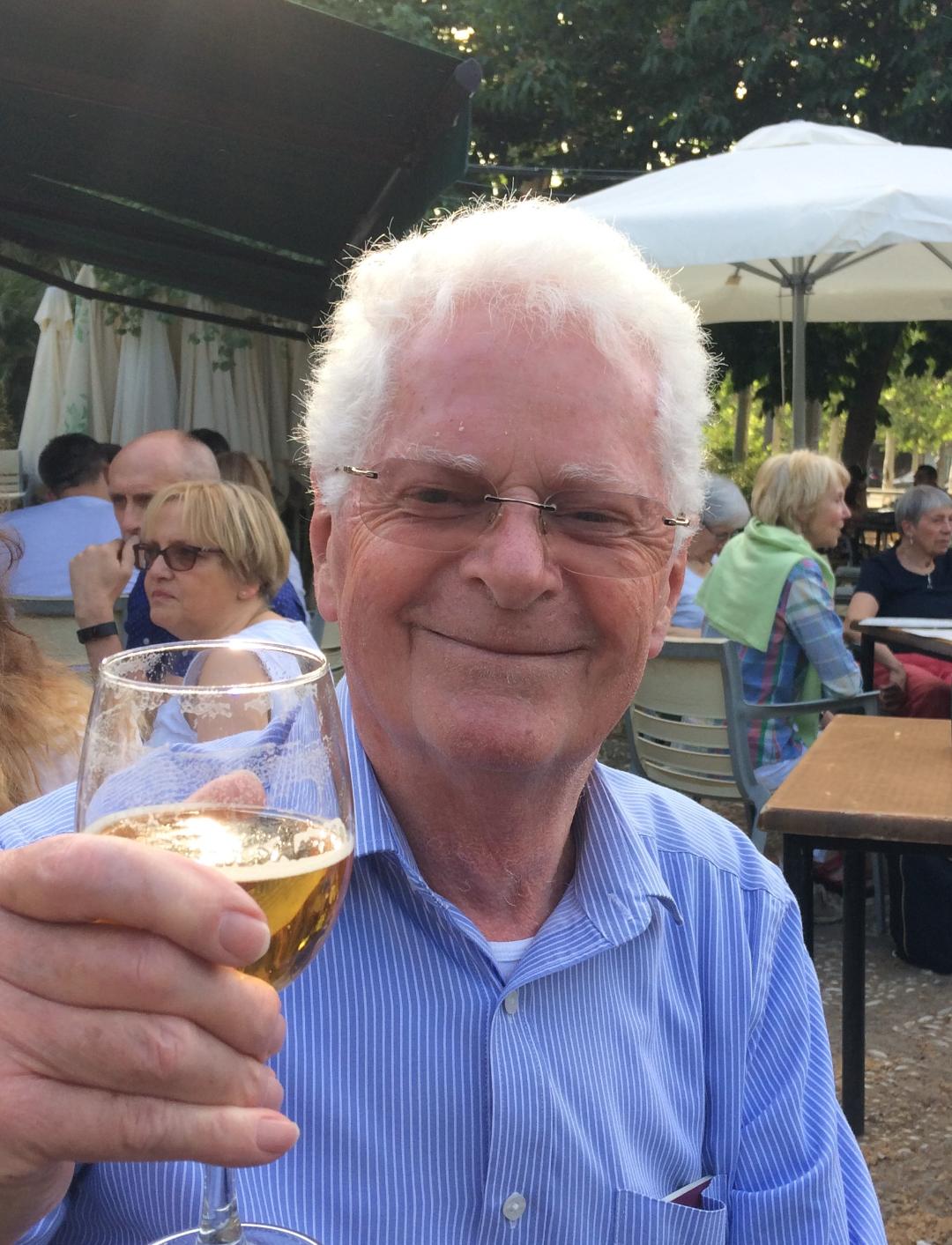 Man holding drink up to camera
