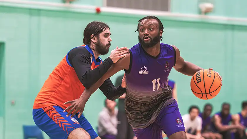 A student playing competitive basketball