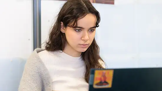 Female student looking at a laptop