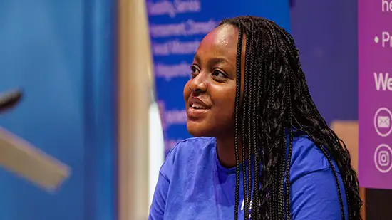 Student in a blue top smiling