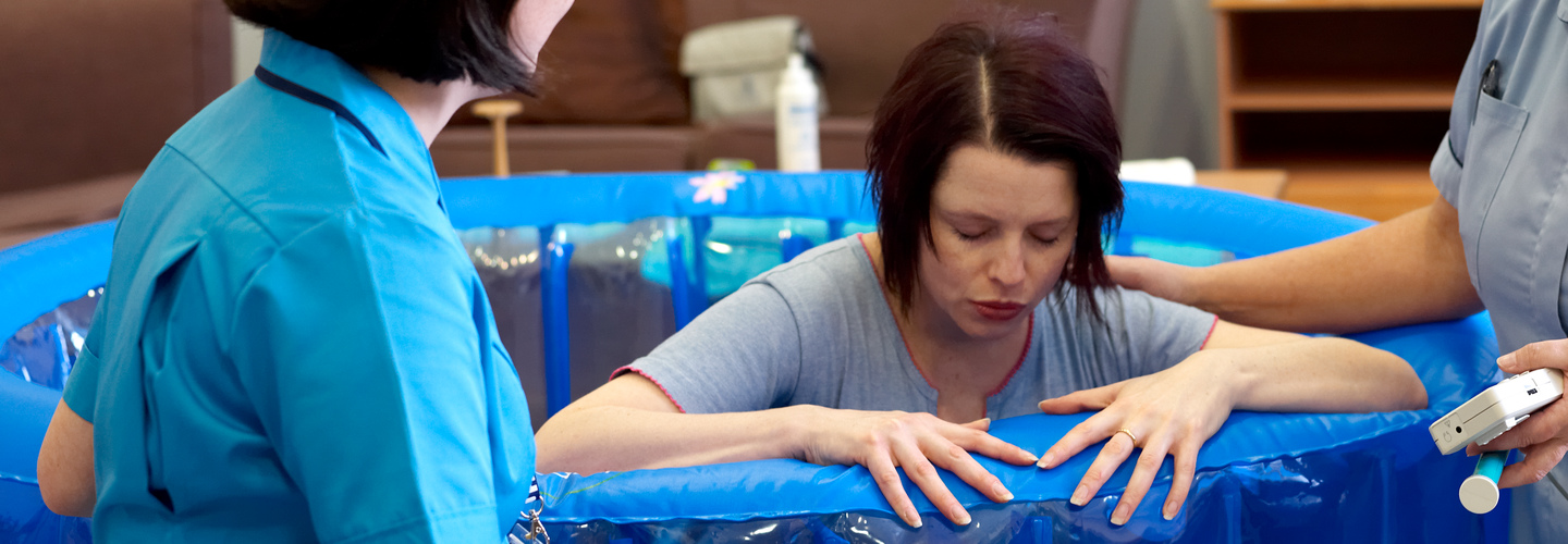 Midwives with a patient in a birthing pool