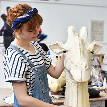 Art student modelling giraffe heard