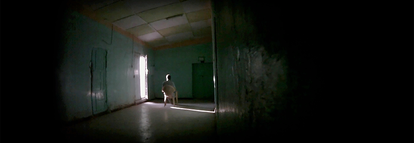 Person on chair in dark room