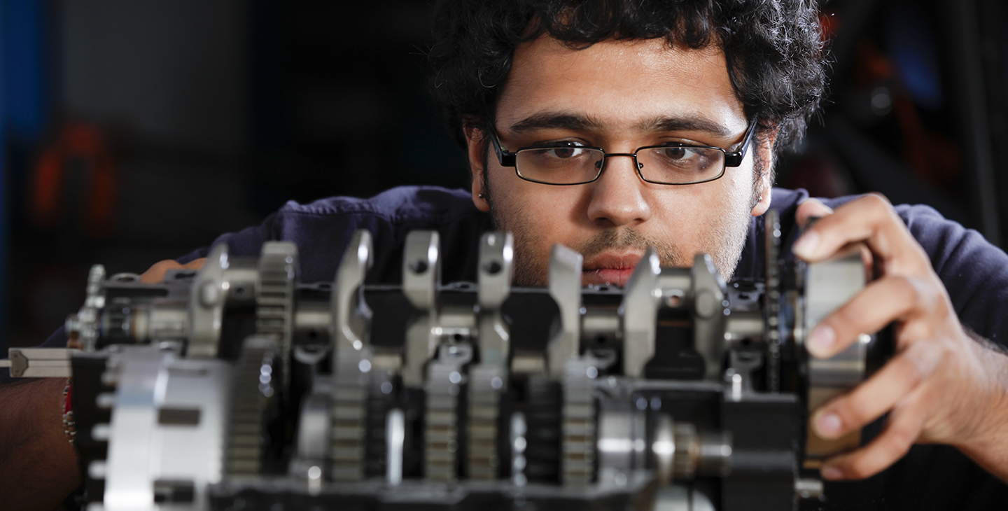 Male student working on engine