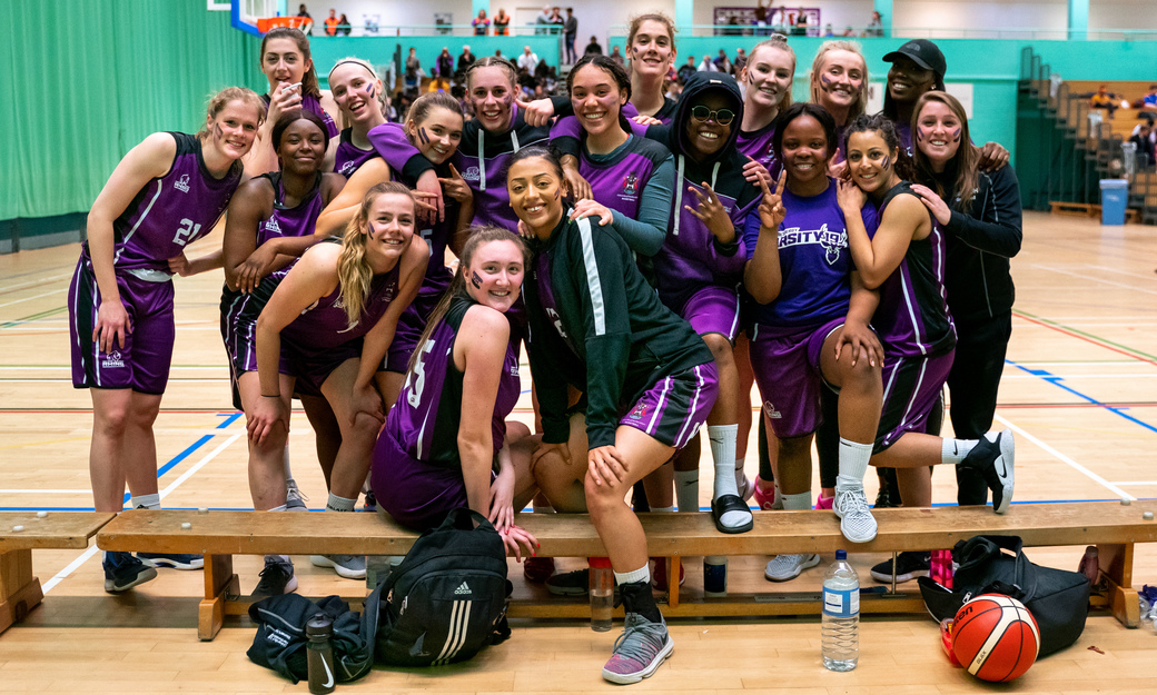 The University's women's basketball team smile to camera