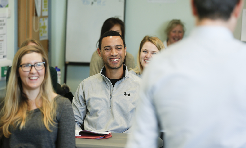 A class in session. The students are laughing and smiling 