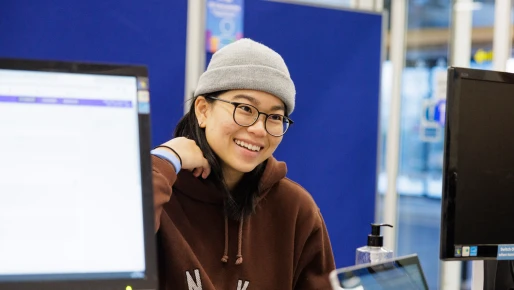 A female student smiling getting information