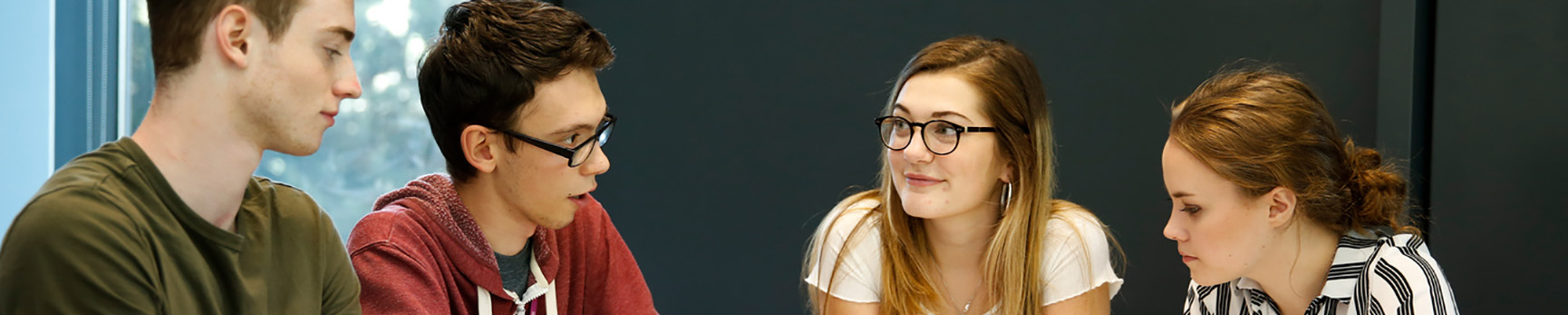 Female and male students talking in seminar