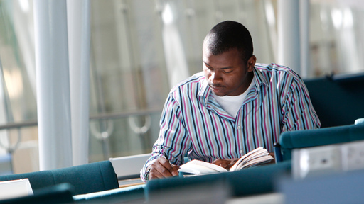 Mature student reading book