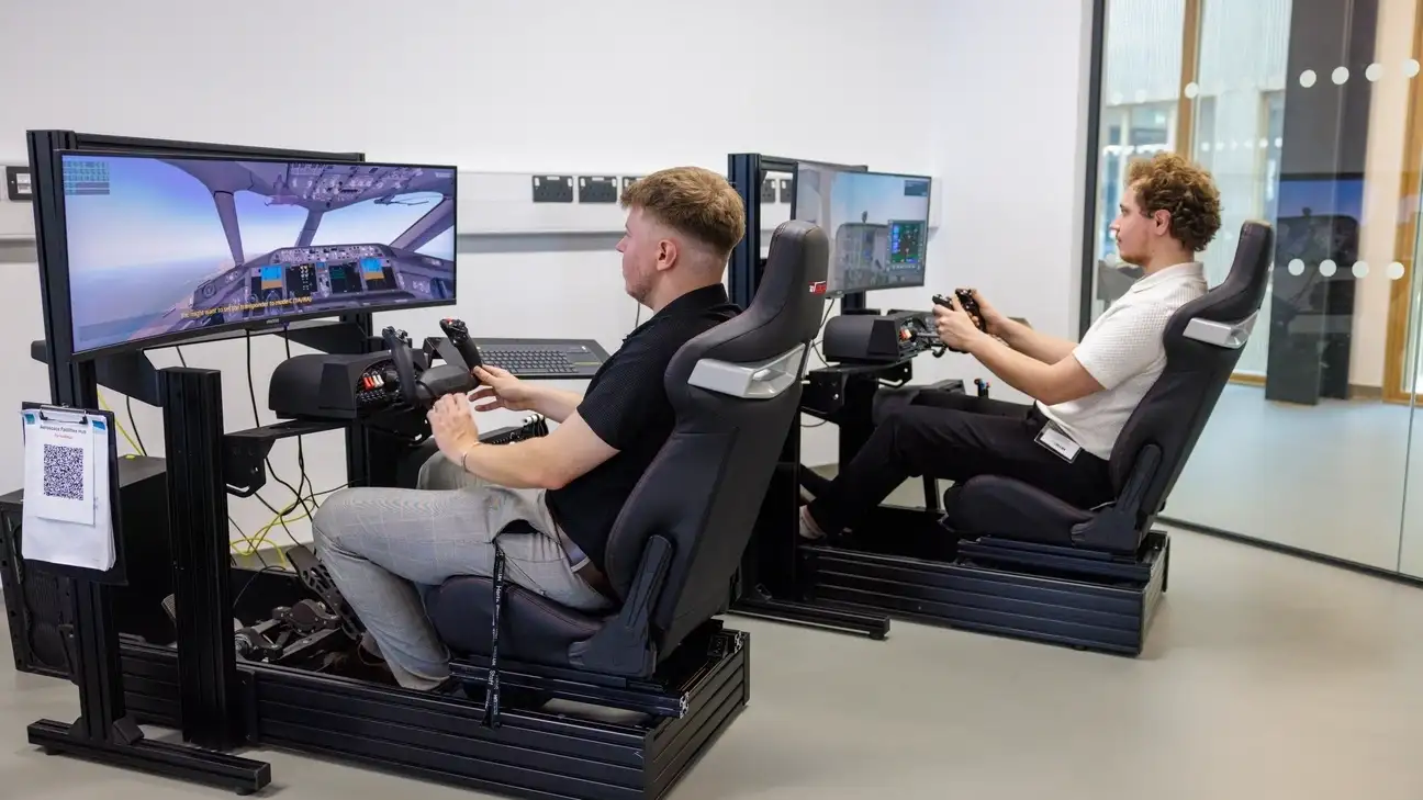 Two students using a flight simulator