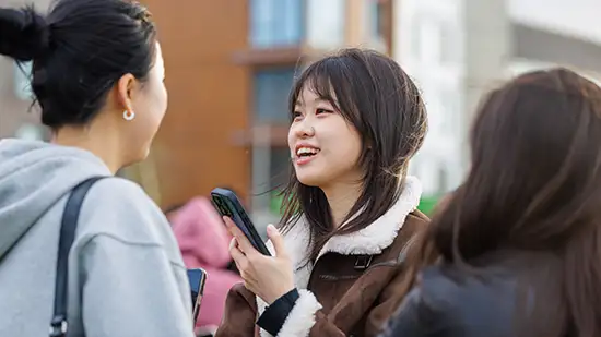 A student smiling and laughing