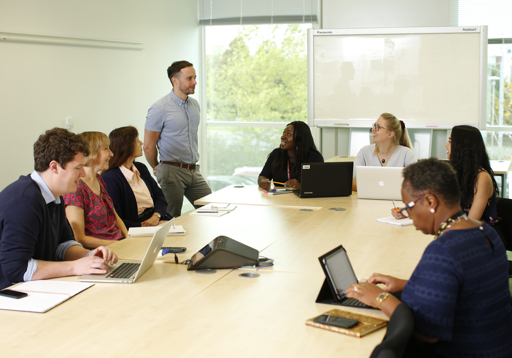 Female and male staff in meeting room