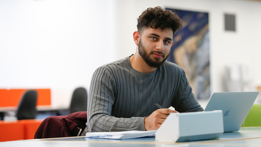 A male student works in Learning Resource Centre