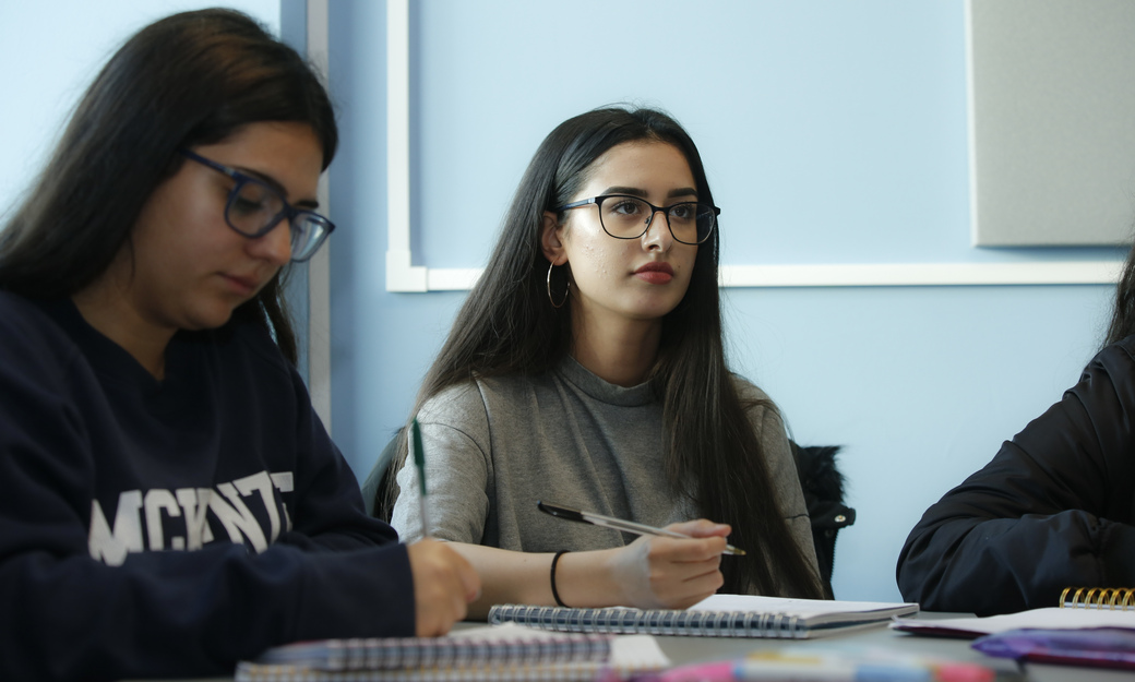 a group of students making notes in class