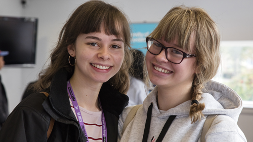 Two students smiling to camera at Welcome Fair