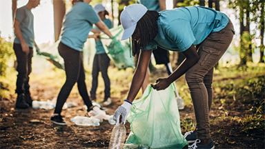 Group of people picking up litter