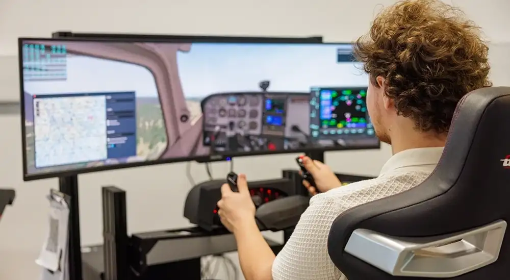 A student using a flight simulator
