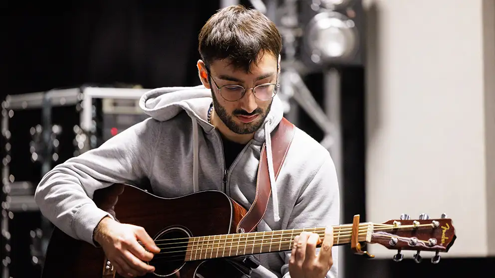 A student playing the guitar