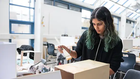 Student painting a box