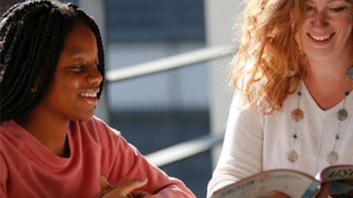 Academic helping student with textbook