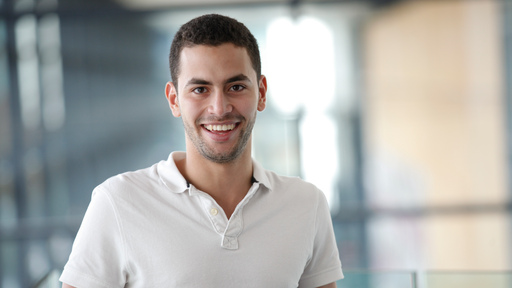 Friendly male student looking into the camera 
