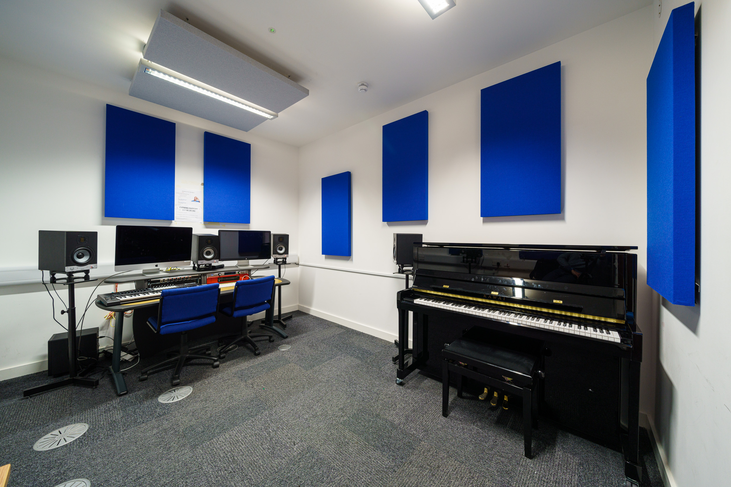 Blue themed practice room with multiple instruments 