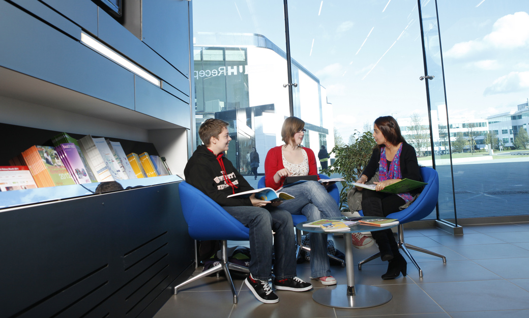 a group of students relaxing and chatting on campus 